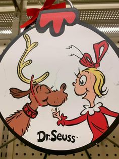 a sign for dr seuss's with a cartoon dog giving it a kiss