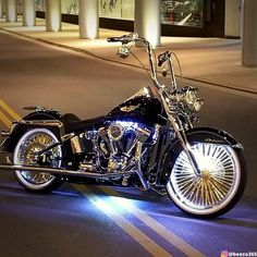 a black motorcycle parked on the street at night