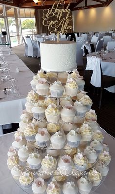 a wedding cake made out of cupcakes on a table