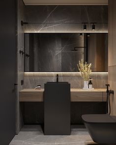 a modern bathroom with marble counter tops and black bathtub in the corner, along with a large mirror