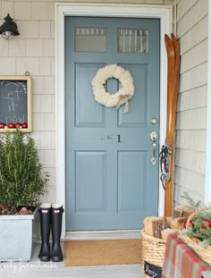 a blue front door with a wreath on it