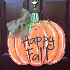 a door hanger that says happy fall with a large orange pumpkin on the front