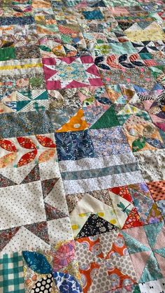 an old quilt is laying on the floor