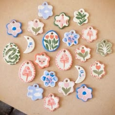 small ceramic ornaments are arranged on a table top, including one for the moon and two for the flowers