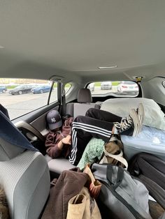 the back seat of a car filled with luggage