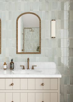 a bathroom vanity with two mirrors above it