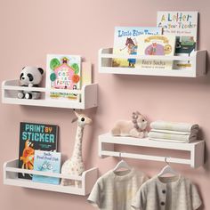 two white shelves with books, toys and other items on them against a pink wall