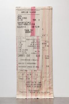 an old movie ticket sitting on top of a wooden table next to a white wall