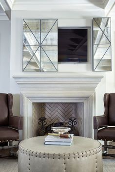 a living room filled with furniture and a fire place in front of a flat screen tv