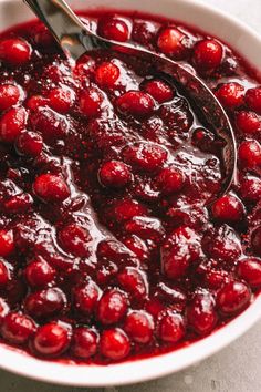 cranberry sauce in a white bowl with a spoon