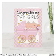 congratulations card for twin girls with two pigs in a pink baby carriage on the front