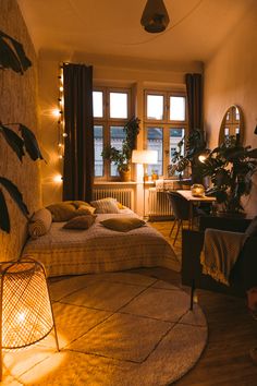 a bed room with a neatly made bed and some lights on the windows sill