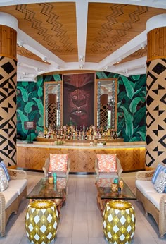 a living room filled with lots of furniture next to a wall covered in art deco