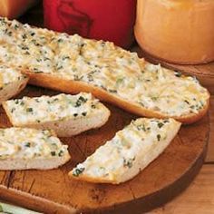 sliced bread with cheese and herbs on a wooden plate