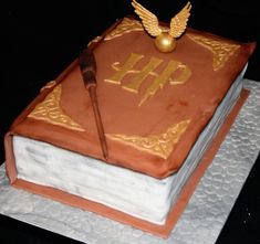 a cake that is sitting on top of a white plate with a book and an eagle