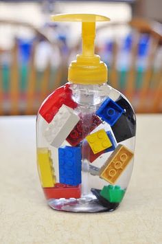 a bottle filled with legos sitting on top of a table