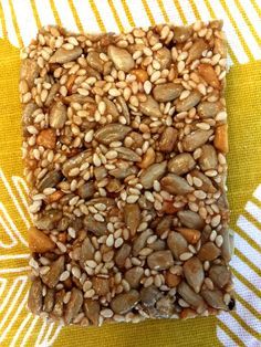 some kind of granola sitting on top of a yellow and white table cloth