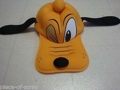 a yellow hat with black ears and eyes on it's head is laying on the floor