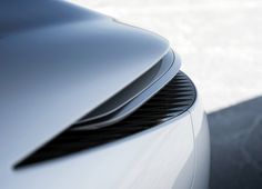 the front end of a silver sports car