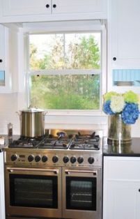 a stove top oven sitting inside of a kitchen