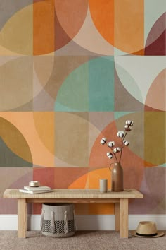 a wooden table sitting in front of a colorful wall