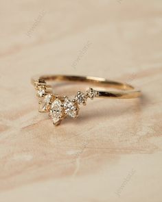 a gold ring with three diamonds on it