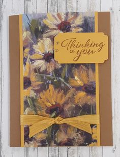 a greeting card with sunflowers on it and a yellow ribbon around the edge