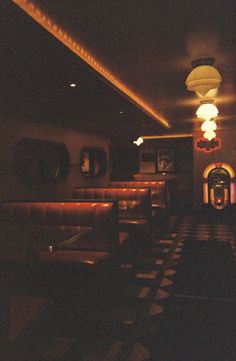 a dimly lit restaurant with checkered flooring