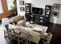 a living room filled with furniture and a flat screen tv on top of a wall