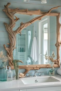 a bathroom with a sink and mirror made out of driftwood