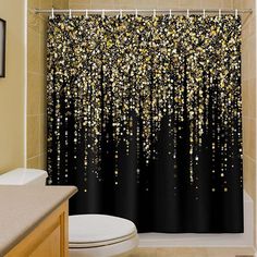 the shower curtain is decorated with gold and black confetti