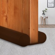 the corner of a room with a wood paneled wall and rug on the floor