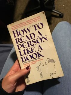 a person is holding up a book in their hand with the title how to read a person like a book