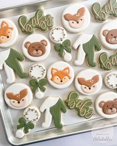 decorated cookies in the shape of animals on a tray