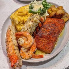 two plates filled with different types of food on top of a white countertop next to each other