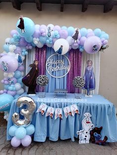 a frozen princess birthday party with balloons and decorations