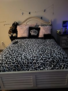 a leopard print comforter and pillows on a bed