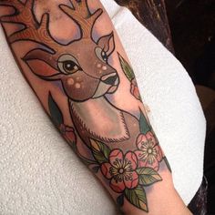 a woman with a deer tattoo on her arm