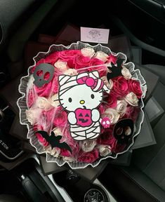 a hello kitty bouquet in the center of a car