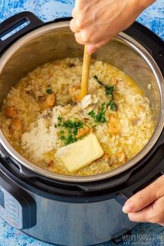 someone is stirring rice in an electric pressure cooker with parsley and butter on top