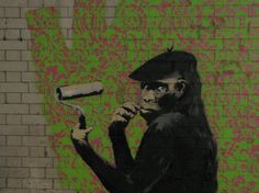 a painting of a monkey holding a hair dryer in front of a brick wall