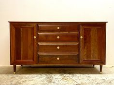 a large wooden cabinet sitting on top of a floor