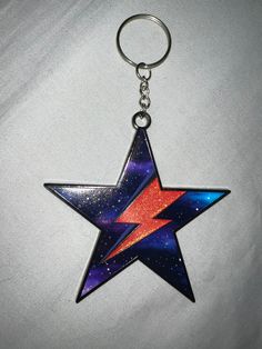 a star shaped keychain on a white surface