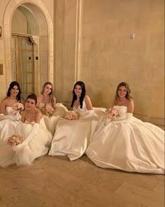 the bridesmaids are posing for a photo in their wedding gowns and bouquets