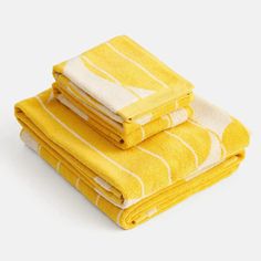 three yellow towels stacked on top of each other