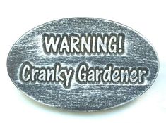 a metal sign that says warning cranky gardener