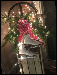 a pair of ice skates with christmas lights on the top and bottom are hanging from a door