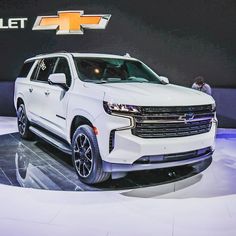 a white chevrolet suv is on display at an auto show