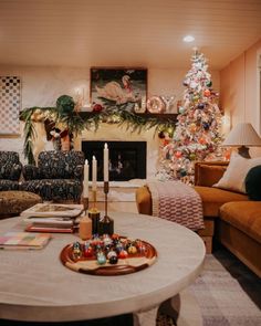 a living room filled with furniture and a christmas tree