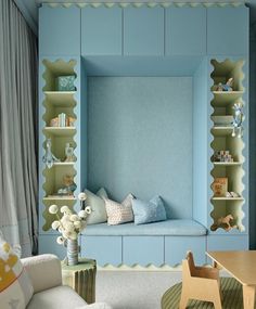 a child's room with blue walls and shelves